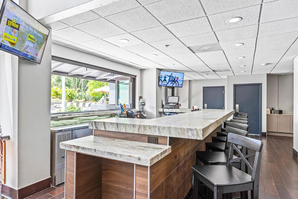 a lobby with a bar with chairs and a tv at Holiday Inn - St. Petersburg West by IHG in St Petersburg