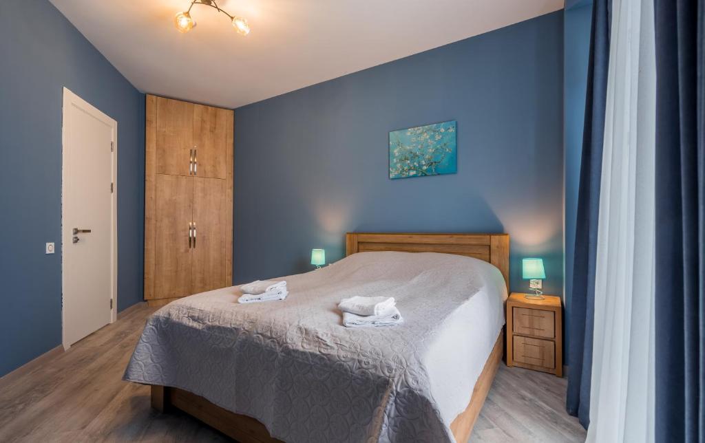 a bedroom with a bed with two towels on it at New Gudauri, Loft 1, #114, Cosy Apartment -Gondola lift in Gudauri