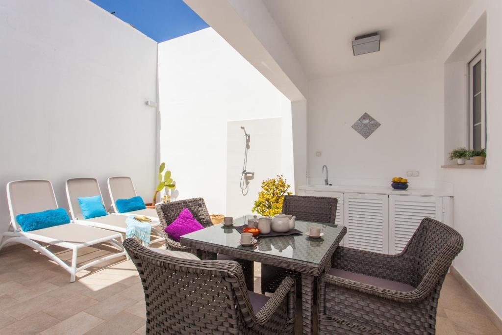 a living room with a table and chairs at Beach House Sa Torre in Colonia Sant Jordi