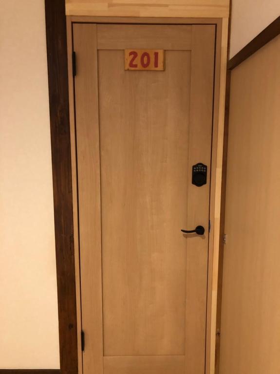 a door with a sign on top of it at Oyado Zen in Kusatsu