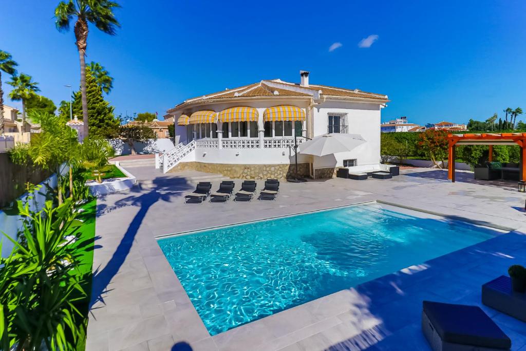 a villa with a swimming pool and a house at Villa Tangstad in Ciudad Quesada