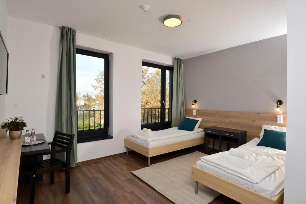 Ένα ή περισσότερα κρεβάτια σε δωμάτιο στο Ludwig Hotel