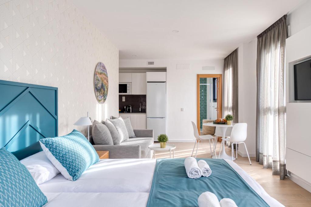 a bedroom with a bed and a living room at Beach Hotel Alfredo in Las Palmas de Gran Canaria