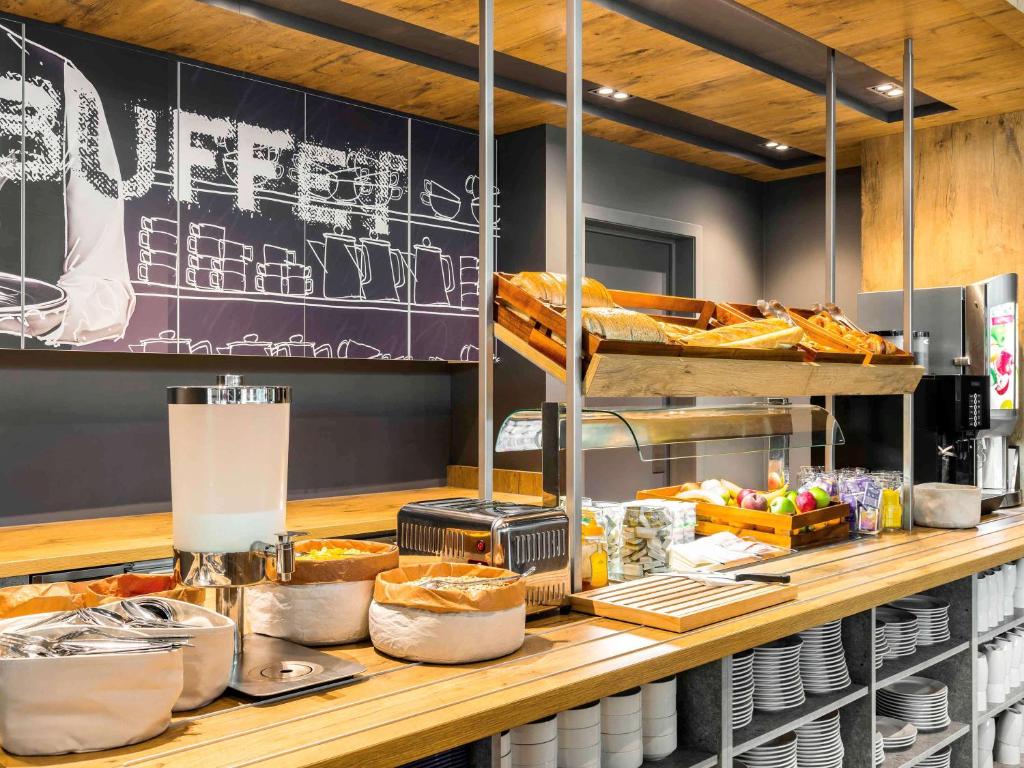 a bakery with a counter with bread and other food at ibis budget Blankenberge in Blankenberge