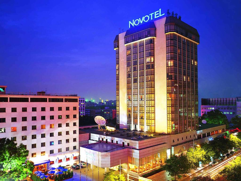 
a large building with a large clock on it at Novotel Beijing Peace in Beijing
