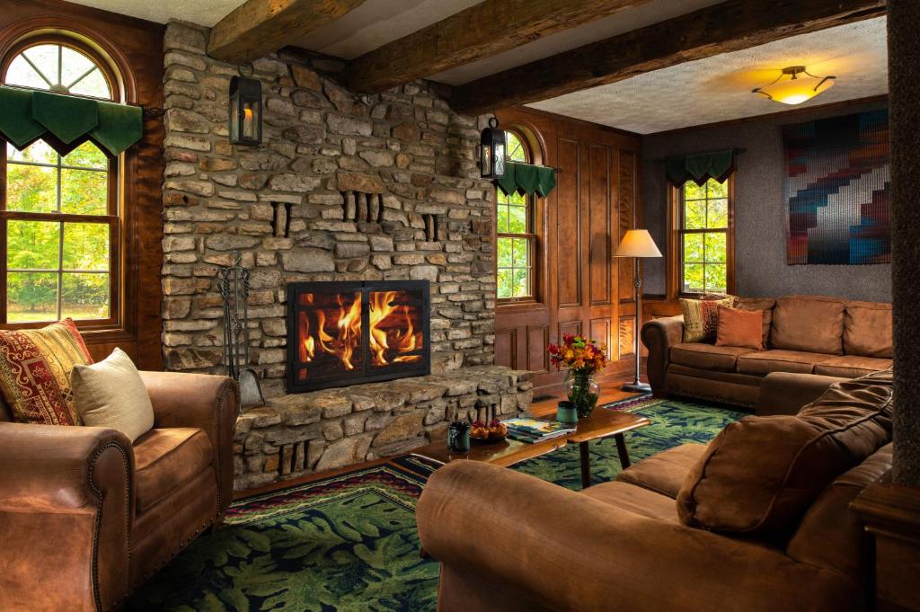 a large living room with a stone fireplace at Paddler's Lane Retreat in Confluence