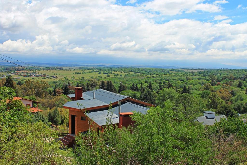a house on the side of a hill with trees at Casas Pura Vida in Villa General Belgrano