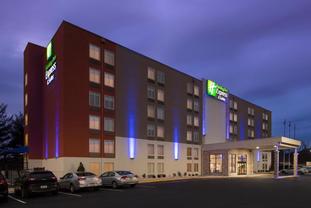 a hotel building with cars parked in a parking lot at Holiday Inn Express & Suites College Park - University Area by IHG in College Park
