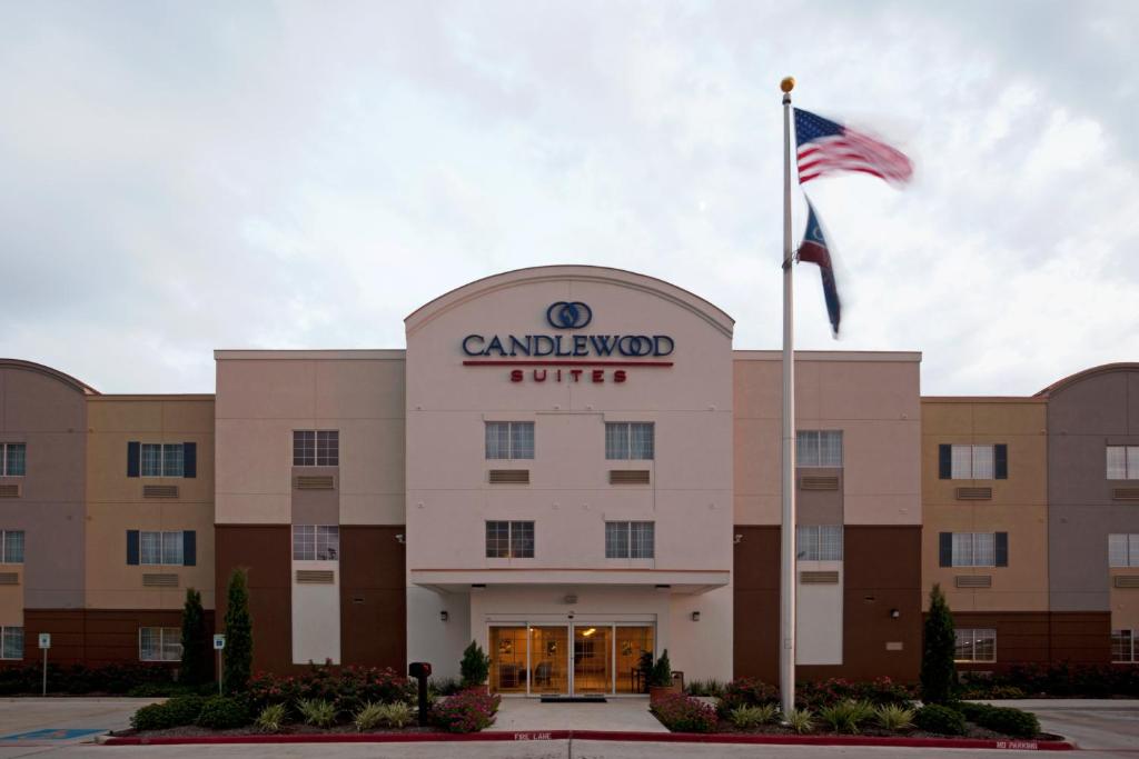 a building with an american flag in front of it at Candlewood Victoria, an IHG Hotel in Victoria