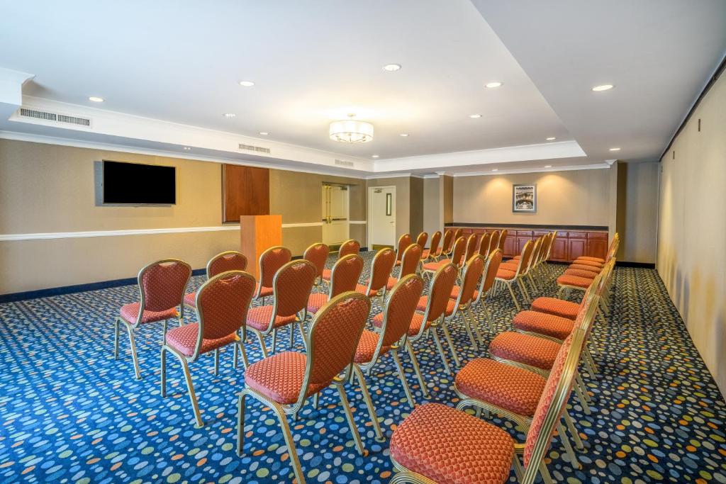 a conference room with chairs and a flat screen tv at Holiday Inn Express Hotel & Suites Easton by IHG in Easton