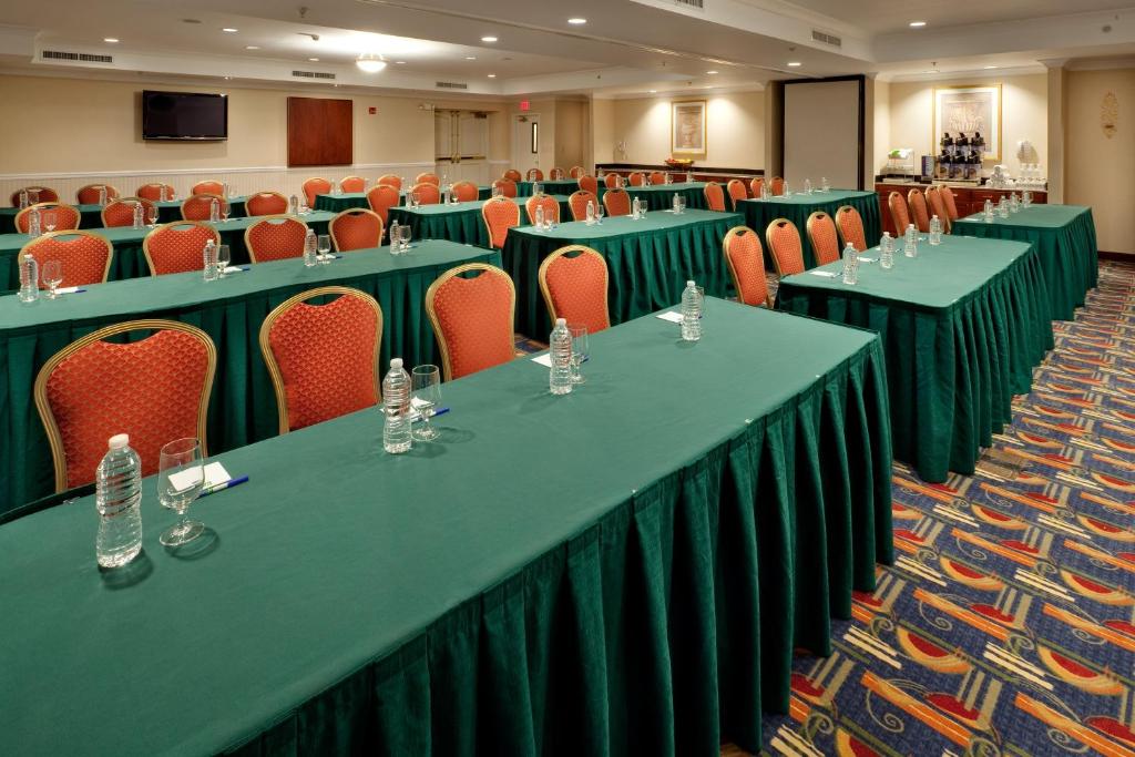 a conference room with green tables and orange chairs at Holiday Inn Express Hotel & Suites Easton by IHG in Easton