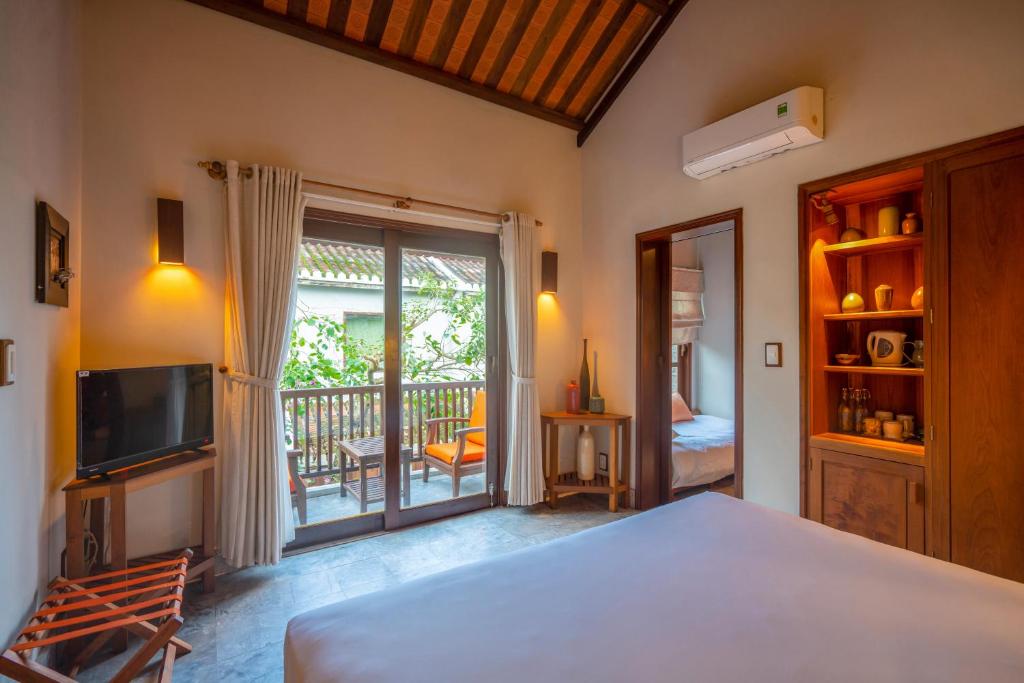 Postel nebo postele na pokoji v ubytování Hoi An Chic - Green Retreat