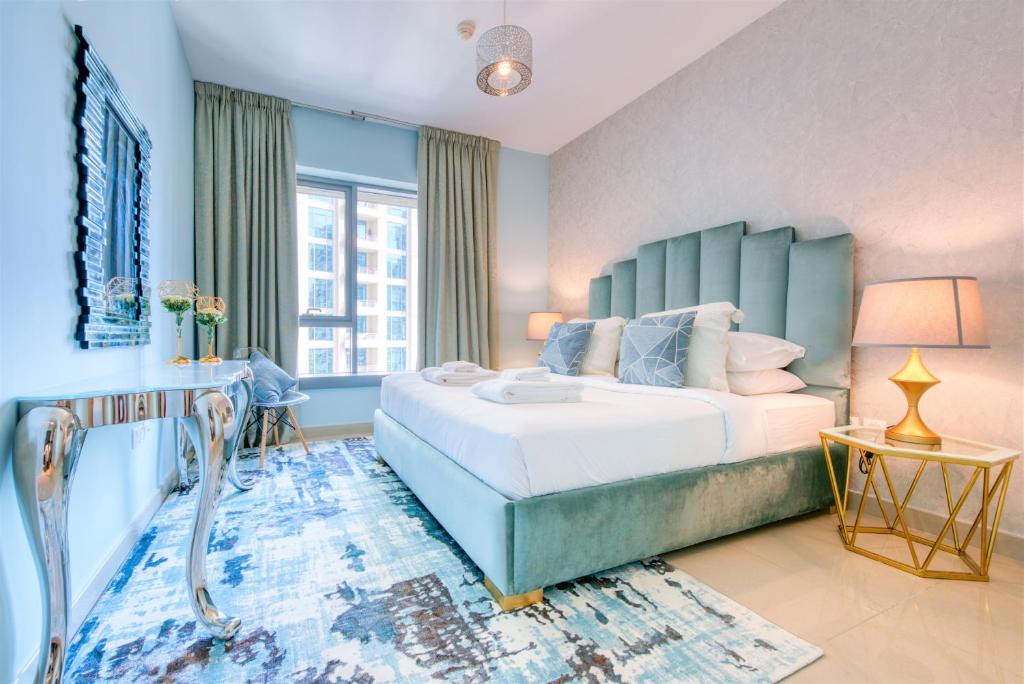 1 dormitorio con 1 cama grande y cabecero azul en Bella Vista - 29 Boulevard Downtown Burj Khalifa, en Dubái