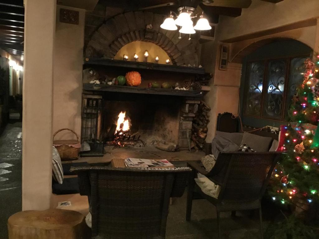 a living room with a fireplace and a christmas tree at Les Artistes Inn in San Diego