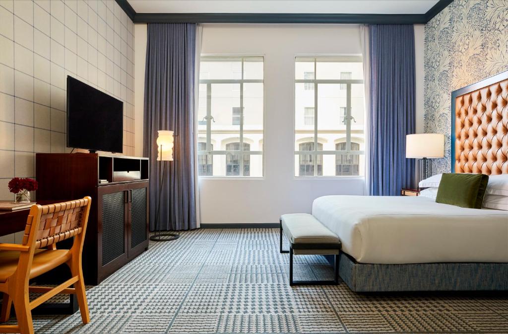 a hotel room with a bed and a television at Kimpton Hotel Monaco Denver by IHG in Denver