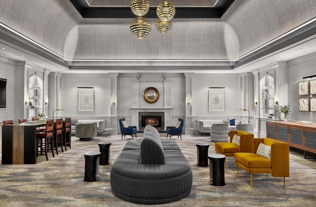 a lobby with chairs and a couch and a fireplace at Kimpton Hotel Monaco Denver, an IHG Hotel in Denver