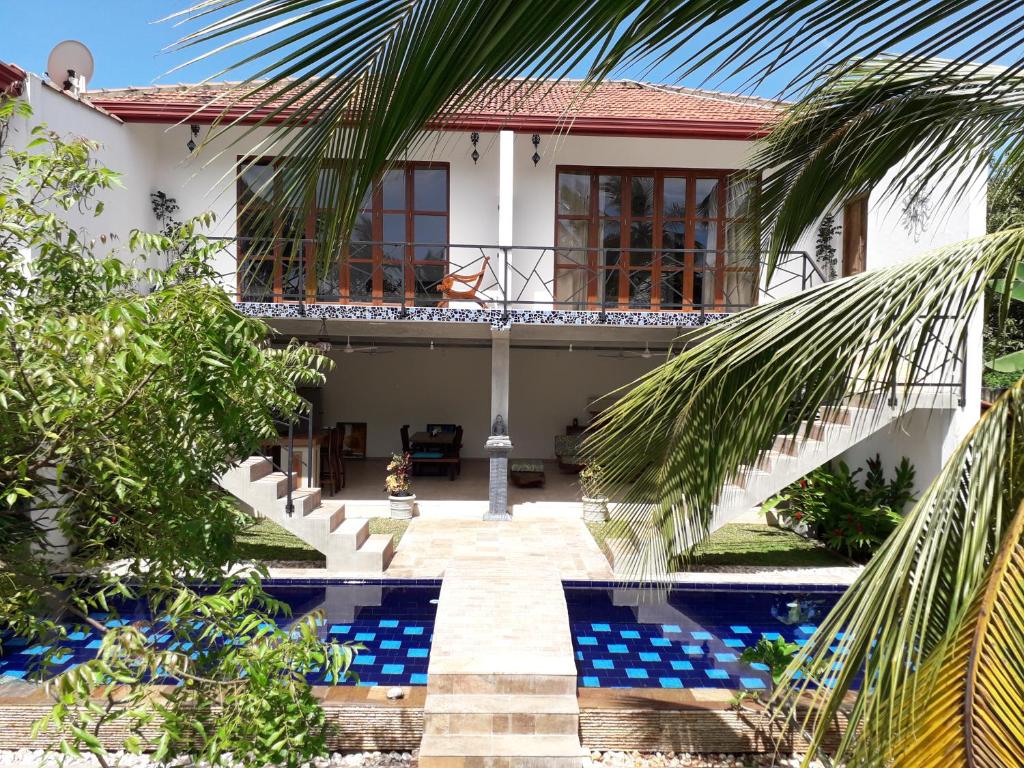 a villa with a swimming pool and a house at villa Mosaic in Tangalle