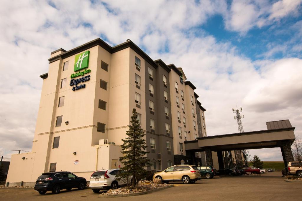 a hotel with cars parked in a parking lot at Holiday Inn Express Edmonton North, an IHG Hotel in Edmonton