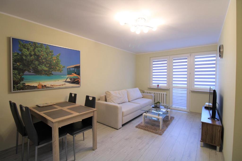 a living room with a couch and a table at Apartament Gdynia KAZART.PL 3 Centrum in Gdynia