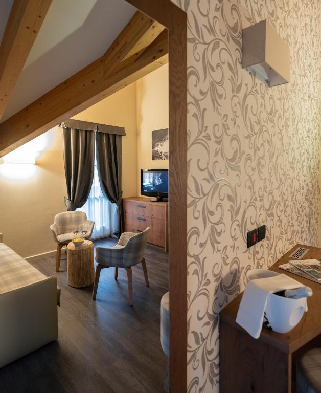 a room with a living room with a room at X Alp Hotel in Pozza di Fassa
