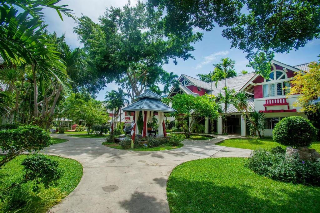 a house with a gazebo in the yard at Natural Park Resort Pattaya in Jomtien Beach