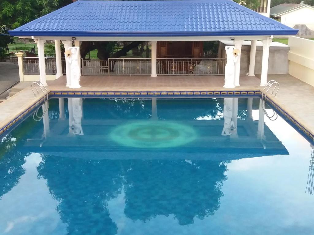 a pool with a gazebo and blue water at Aikaterinis in San Narciso