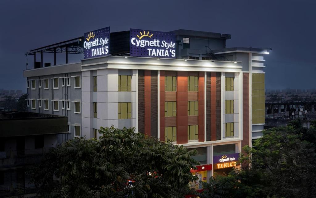 a building with a sign on top of it at Cygnett Style Tania's in Siliguri