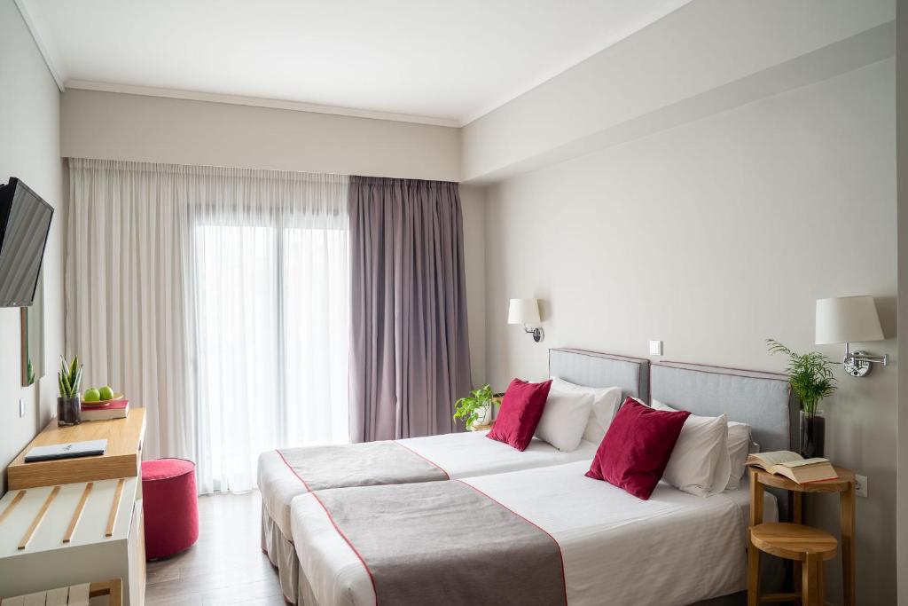 Posteľ alebo postele v izbe v ubytovaní CHROMA FASHION ROOMS & APARTMENTS