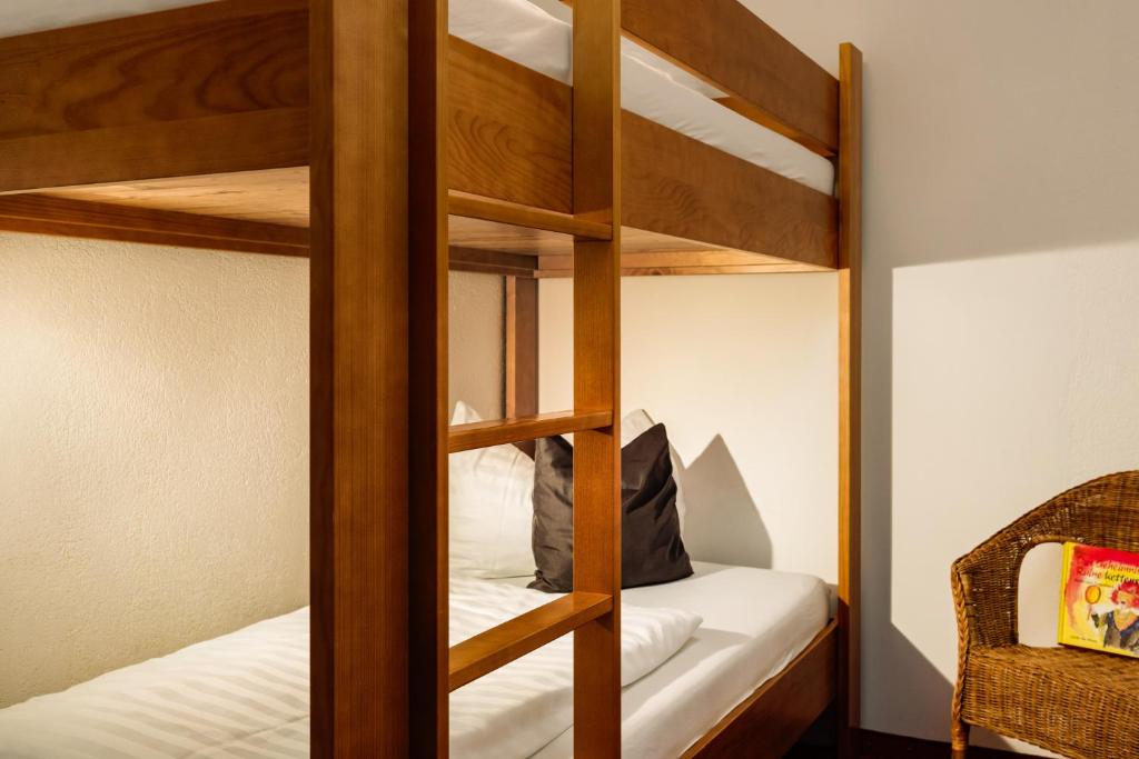 Postel nebo postele na pokoji v ubytování Hotel Kögele mit Restaurant bei Innsbruck Axamer Lizum