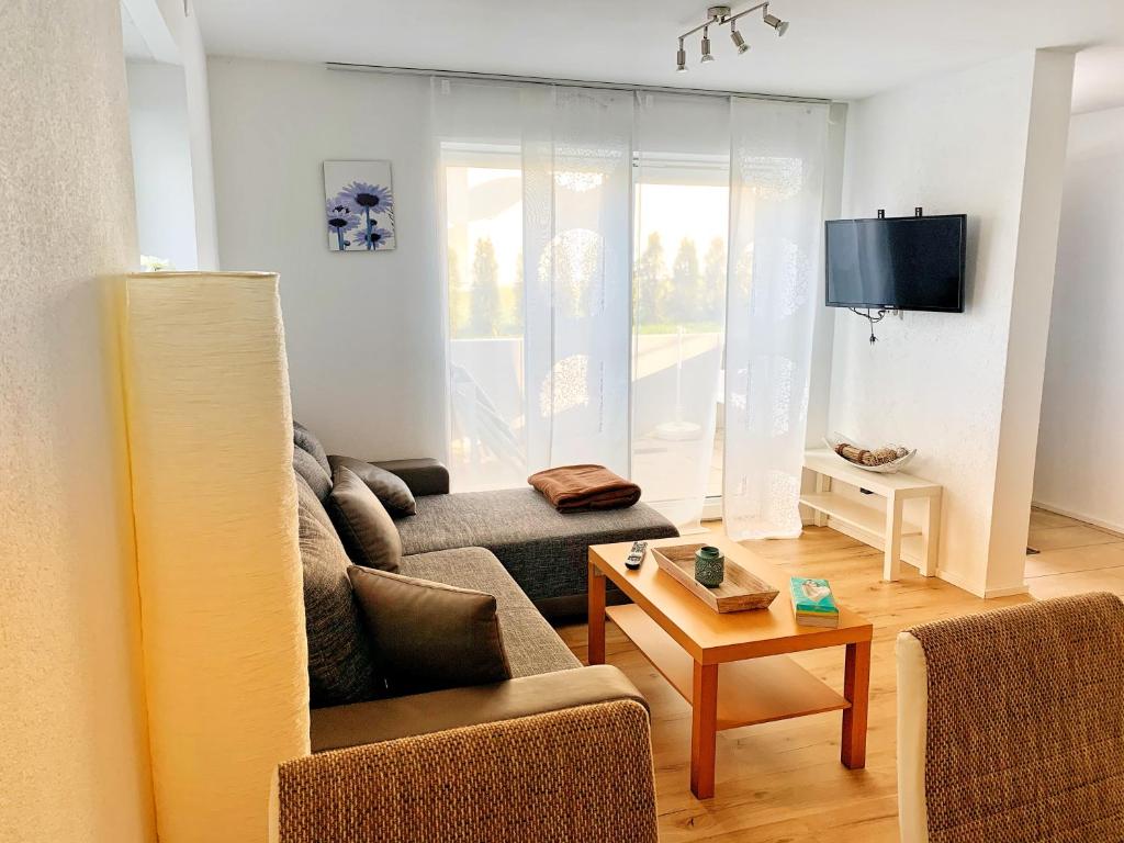 a living room with a couch and a table at Ferienwohnung Deifel in Schömberg