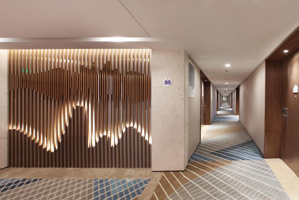 a hallway with a wall with a design on it at Holiday Inn Express Guilin City Center, an IHG Hotel in Guilin