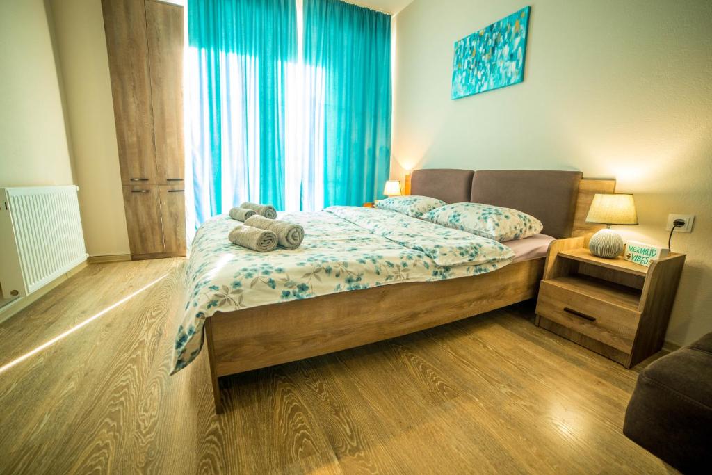 a bedroom with a bed with a teddy bear on it at BAKURIANI PLAZA A-208 in Bakuriani