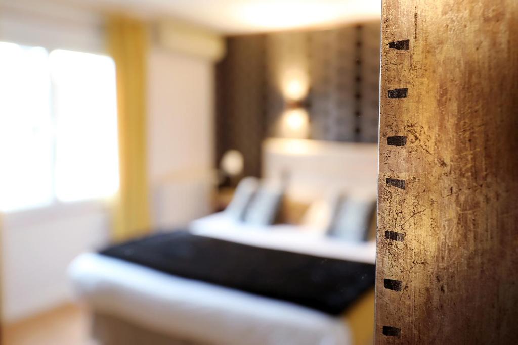 Letto o letti in una camera di Hotel Les Pasteliers