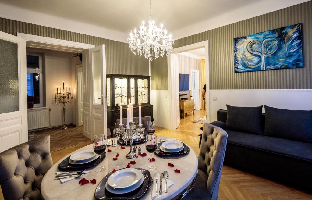 a living room with a table and a couch at Sophies Place Augarten - Imperial Lifestyle City Apartments Vienna Parking in Vienna