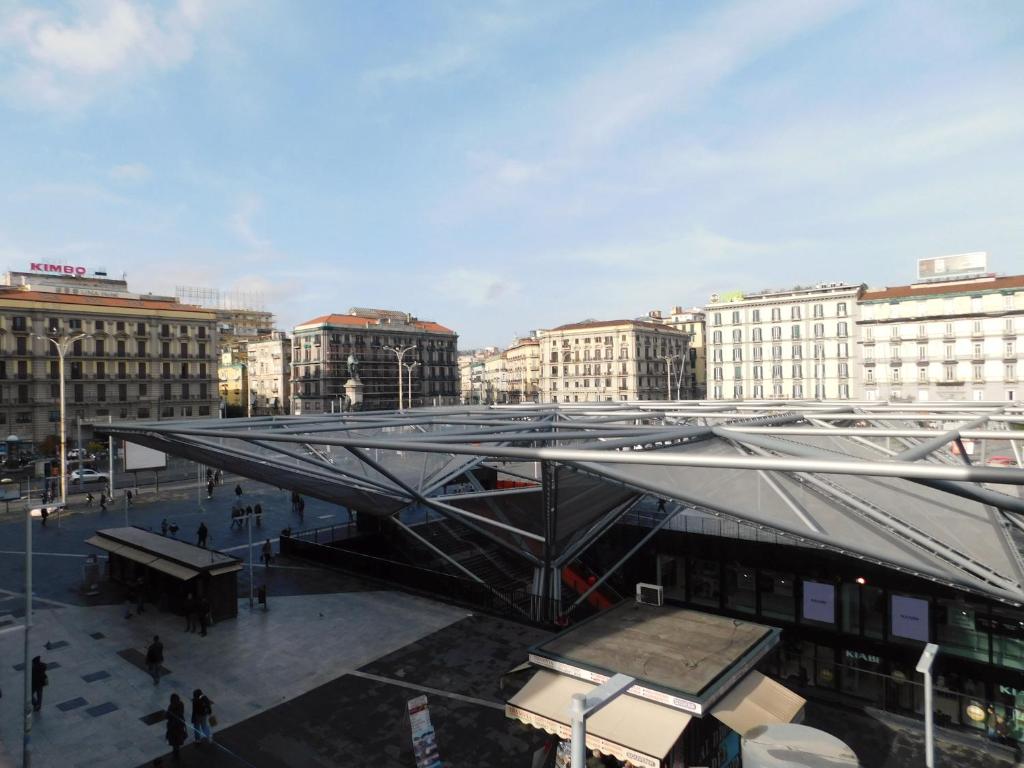 a building with a metal roof in a city at Scaramantico Rooms in Naples