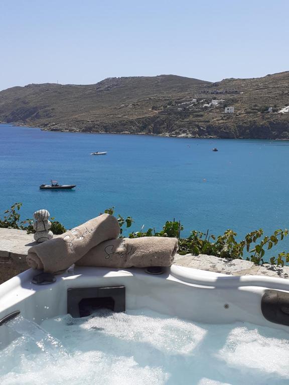 a bath tub with a view of a body of water at Sea Side Studios & Houses in Kalo Livadi