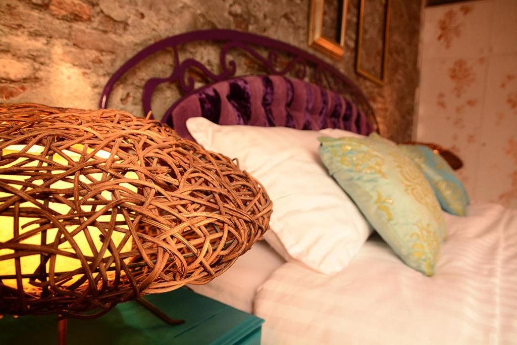 a bed with pillows and a basket on top of it at Sarajevo Boutique in Sarajevo