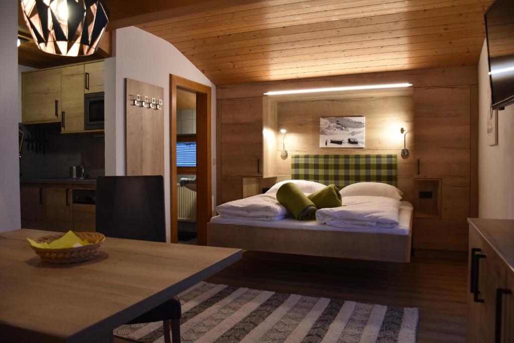 a bedroom with a bed in the middle of a kitchen at Gästehaus Emberger in Wagrain