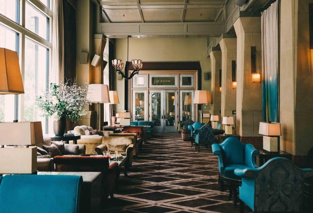 a lobby with chairs and couches in a building at Soho Grand Hotel in New York