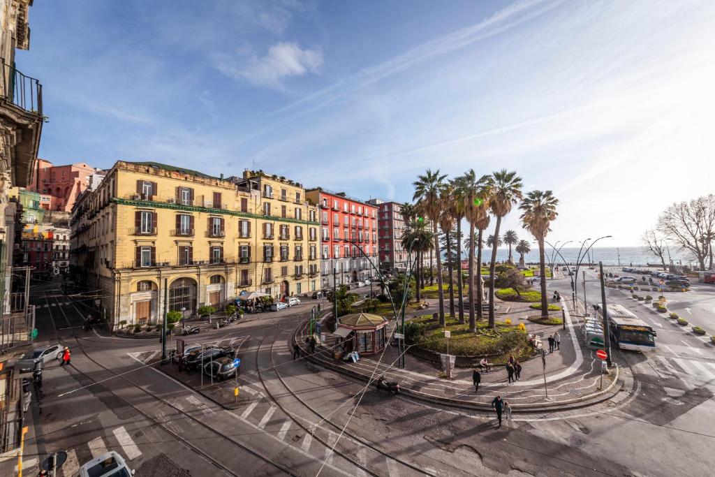 a street in a city with palm trees and buildings at B&B Palazzo Satriano in Naples