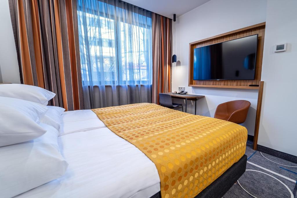 Postel nebo postele na pokoji v ubytování Hestia Hotel Kentmanni