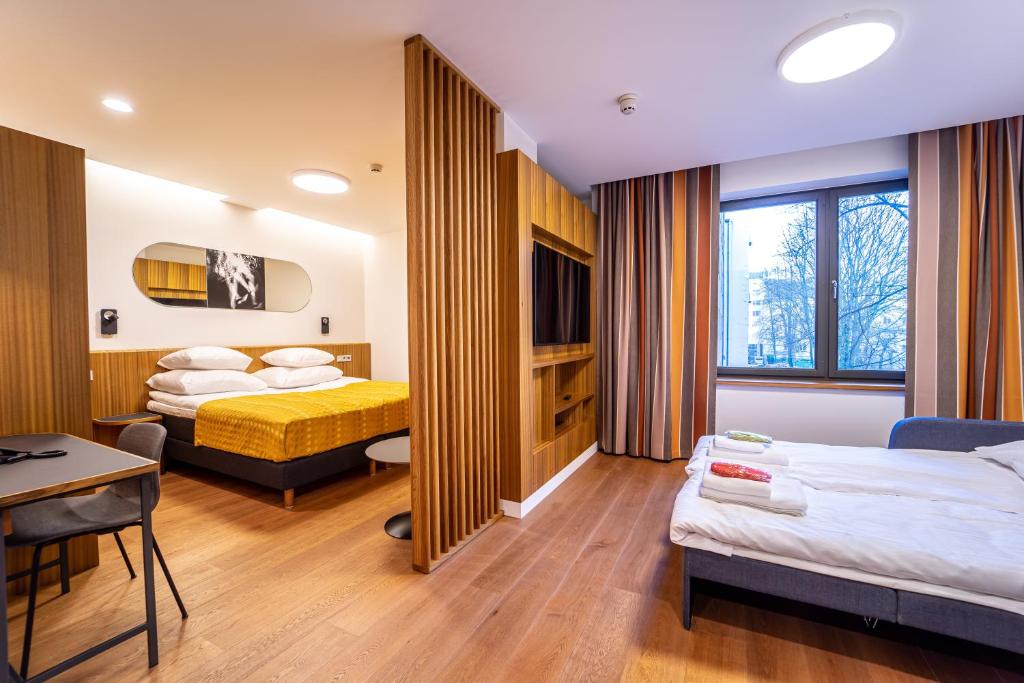 Postel nebo postele na pokoji v ubytování Hestia Hotel Kentmanni