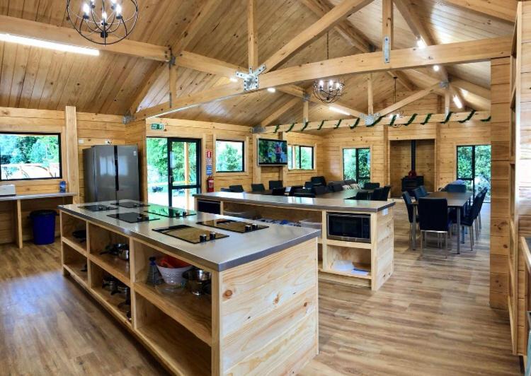 a large kitchen and dining room in a log cabin at Kingston TOP 10 Holiday Park in Kingston