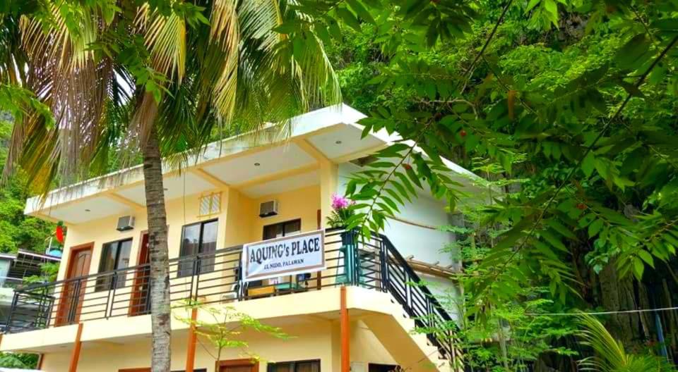 a building with a sign for a hotel at Aquing's Place in El Nido