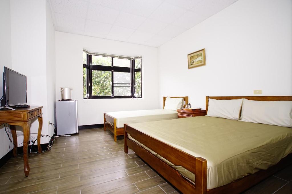 Postel nebo postele na pokoji v ubytování Fumei Bluebird Homestay