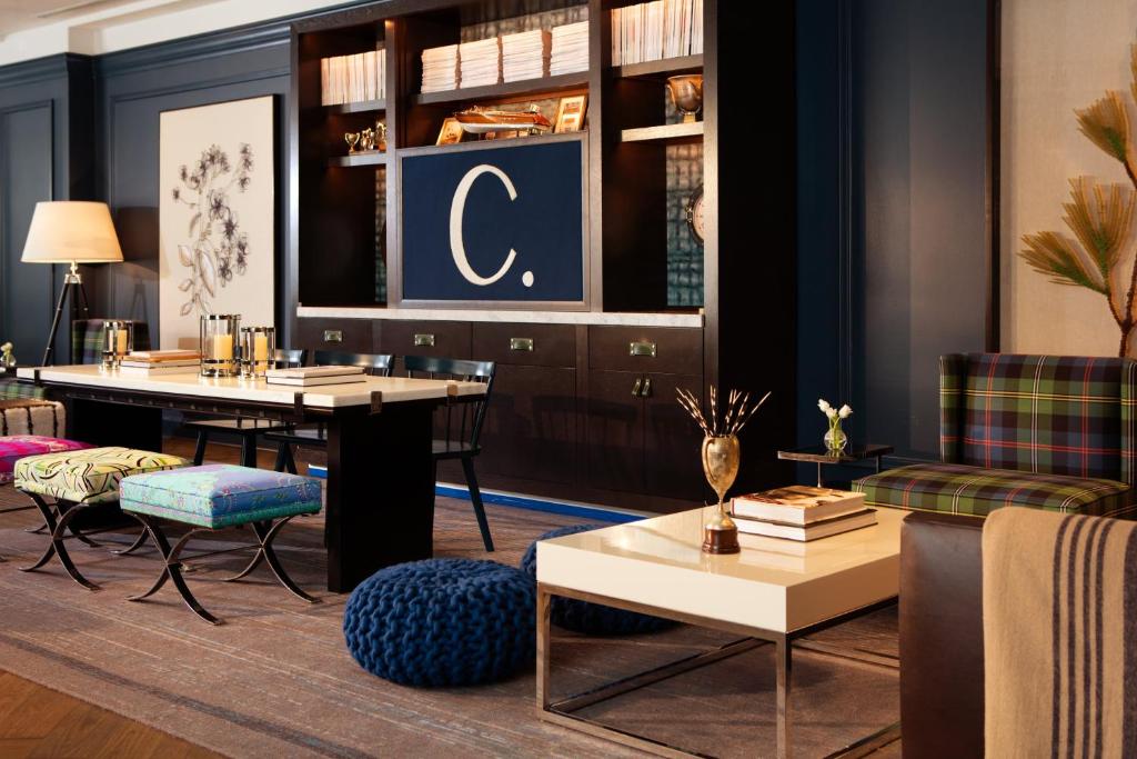 a living room with a table and chairs at Kimpton Cardinal Hotel, an IHG Hotel in Winston-Salem