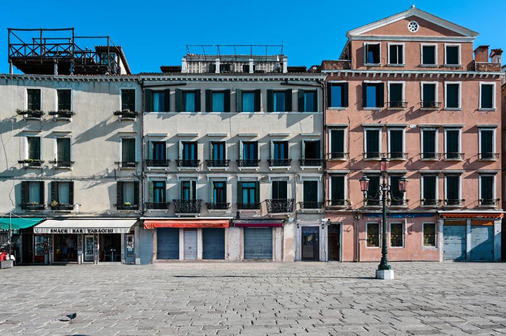 a large building with a clock on top of it at A Tribute To Music Residenza in Venice