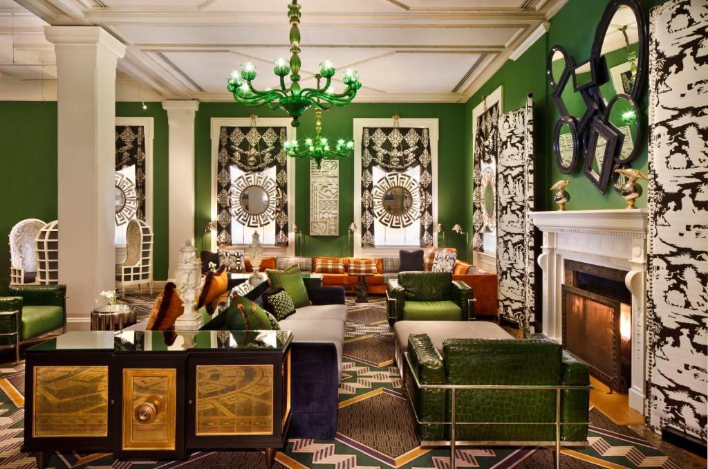 a living room with green walls and a fireplace at Kimpton Hotel Monaco Washington DC, an IHG Hotel in Washington, D.C.