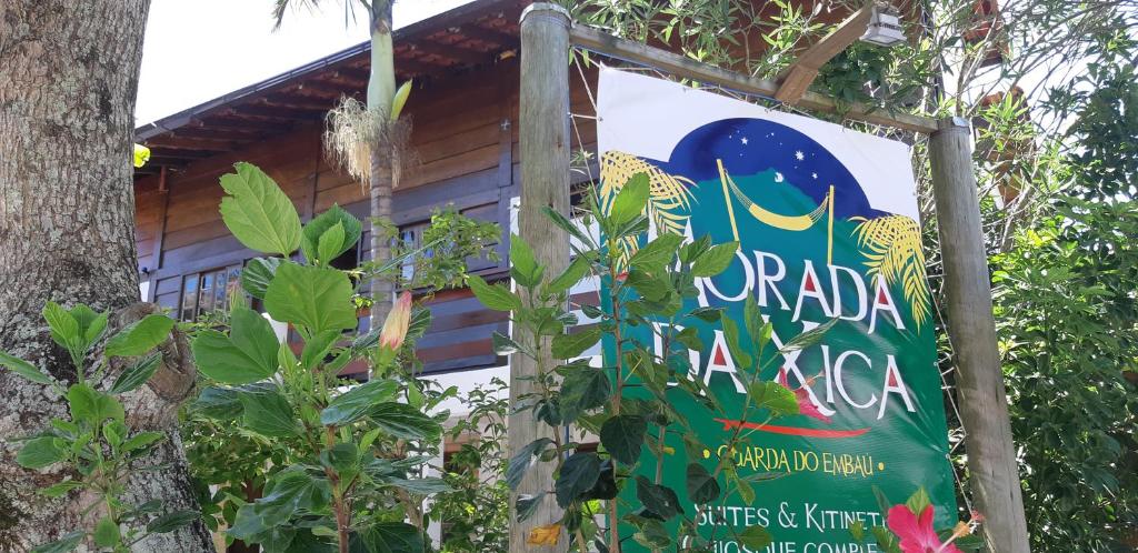 a sign for a restaurant in a tree at Guarda do Embaú in Guarda do Embaú