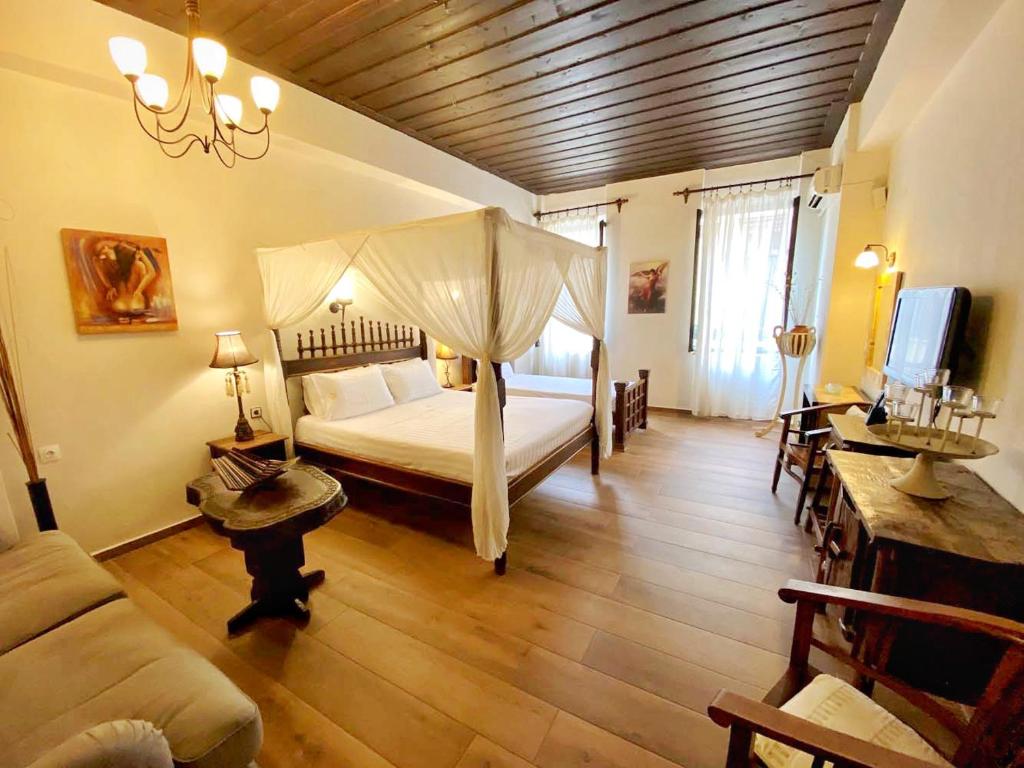 a bedroom with a canopy bed and a couch at Boutique Hotel Del Doge in Chania Town